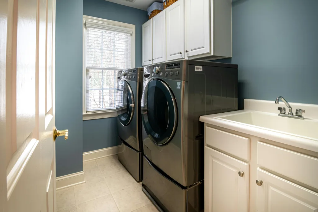 Clean modern laundry room wall with a visible dryer vent — ideal setup for DIY vent cleaning