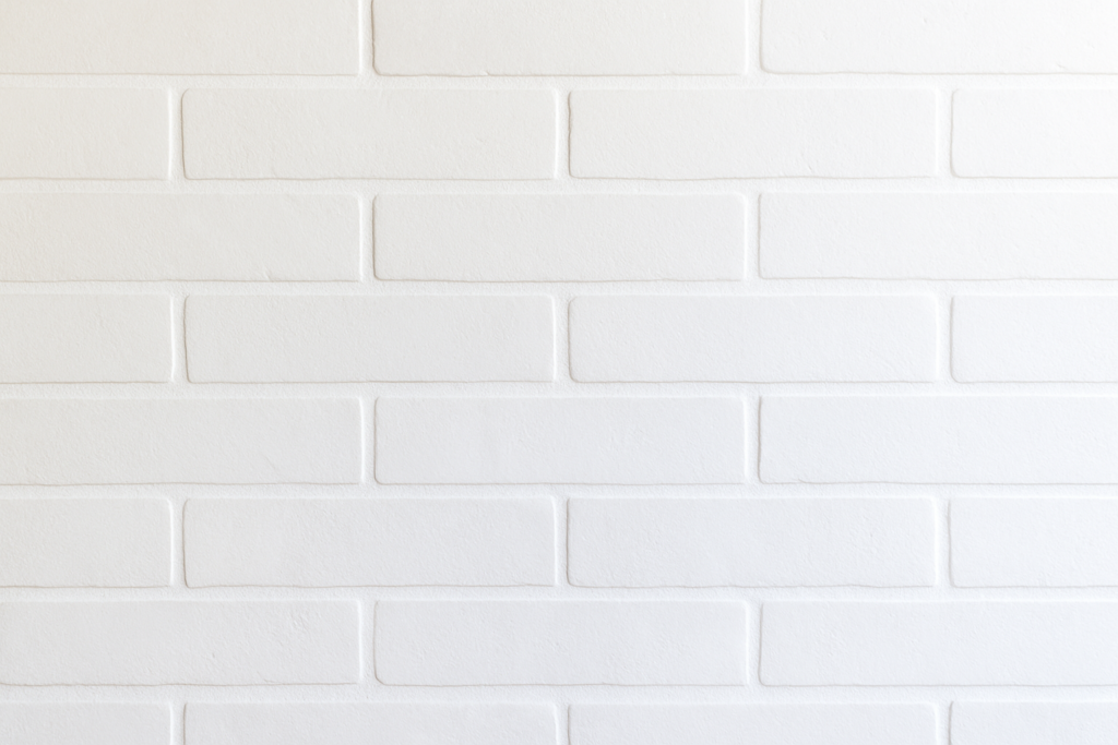 White subway tile wall with a soft white-to-gray gradient, creating a clean modern background for DIY home improvement website hero section